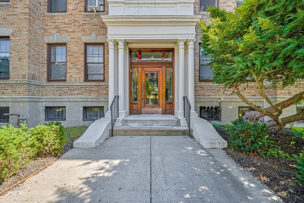 4 Crawford Street, Unit U4 Cambridge, MA 02139 - Photo 21 of 22 a front view of a house with yard