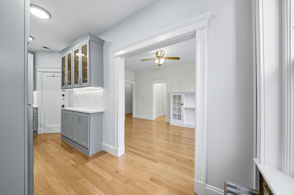 4 Crawford Street, Unit U4 Cambridge, MA 02139 - Photo 8 of 22 a view of a hallway with wooden floor and a bathroom