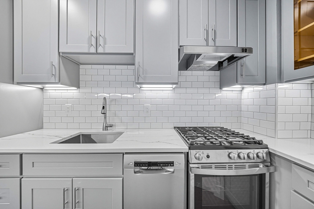 4 Crawford Street, Unit U4 Cambridge, MA 02139 - Photo 10 of 22 a kitchen with a sink stove and cabinets