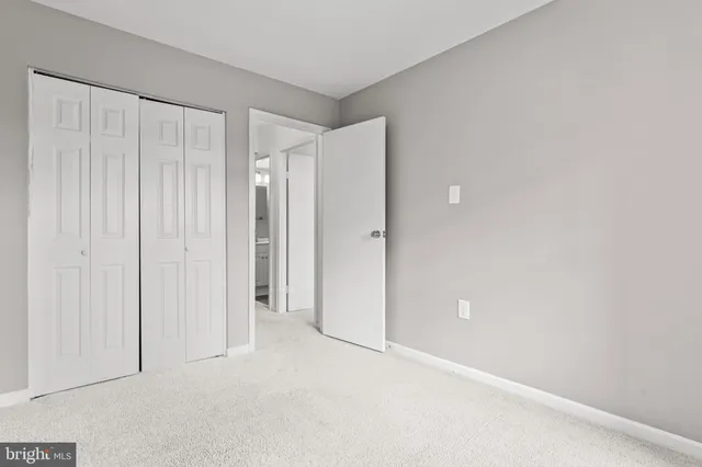 a view of an empty room with closet area
