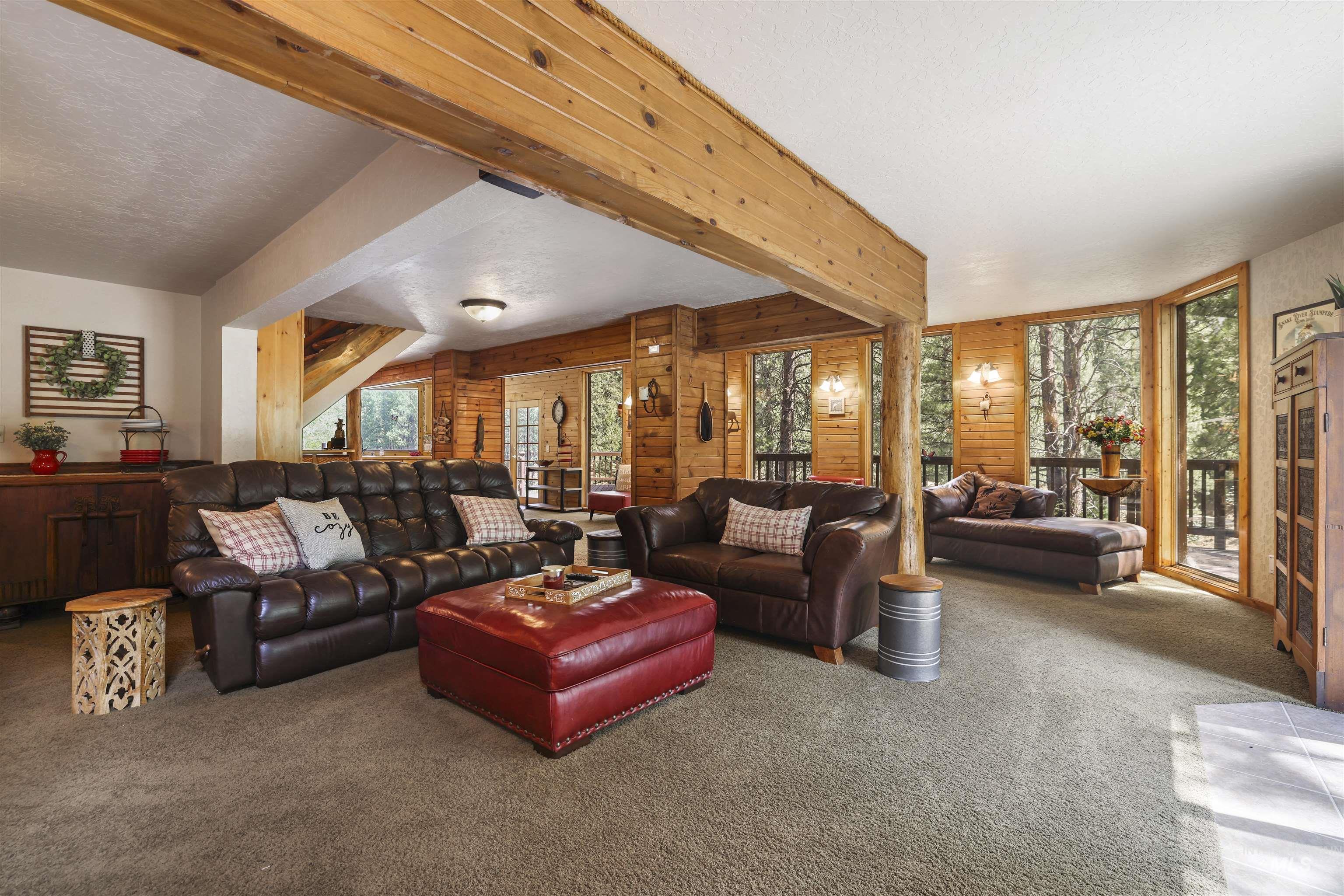 224 Dakota Road Mountain Home, ID 83647 - Photo 5 of 50 Spacious living area featuring extensive wood-finish wall paneling and exposed wood beams