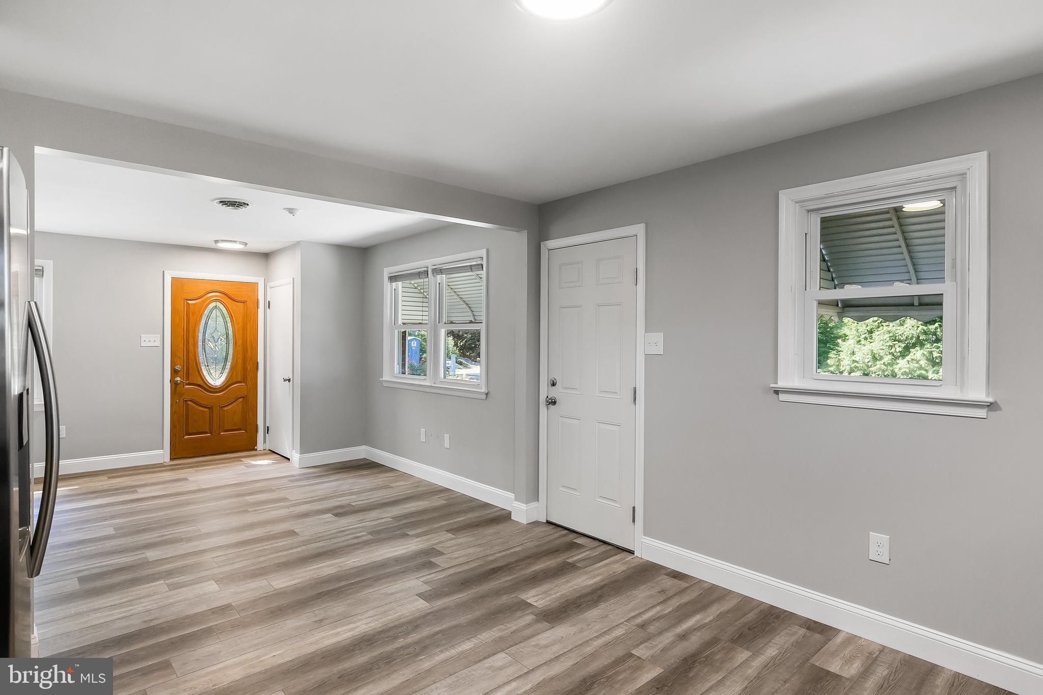 405 Hamilton Road Glassboro, NJ 08028 - Photo 12 of 28 a view of an empty room with window and wooden floor