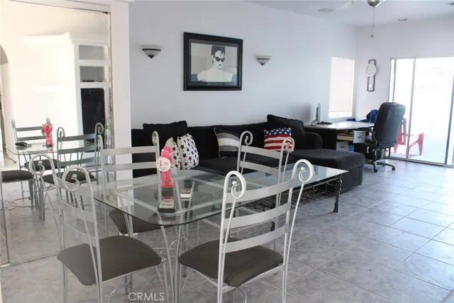 a dining room with furniture a rug and a chandelier