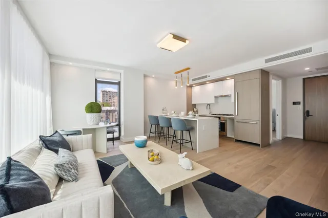 a living room with furniture and kitchen view