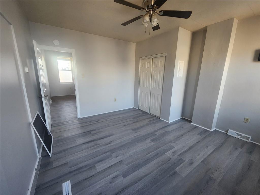 306 Campbell Street McKees Rocks, PA 15136 - Photo 13 of 28 an empty room with wooden floor fan and windows