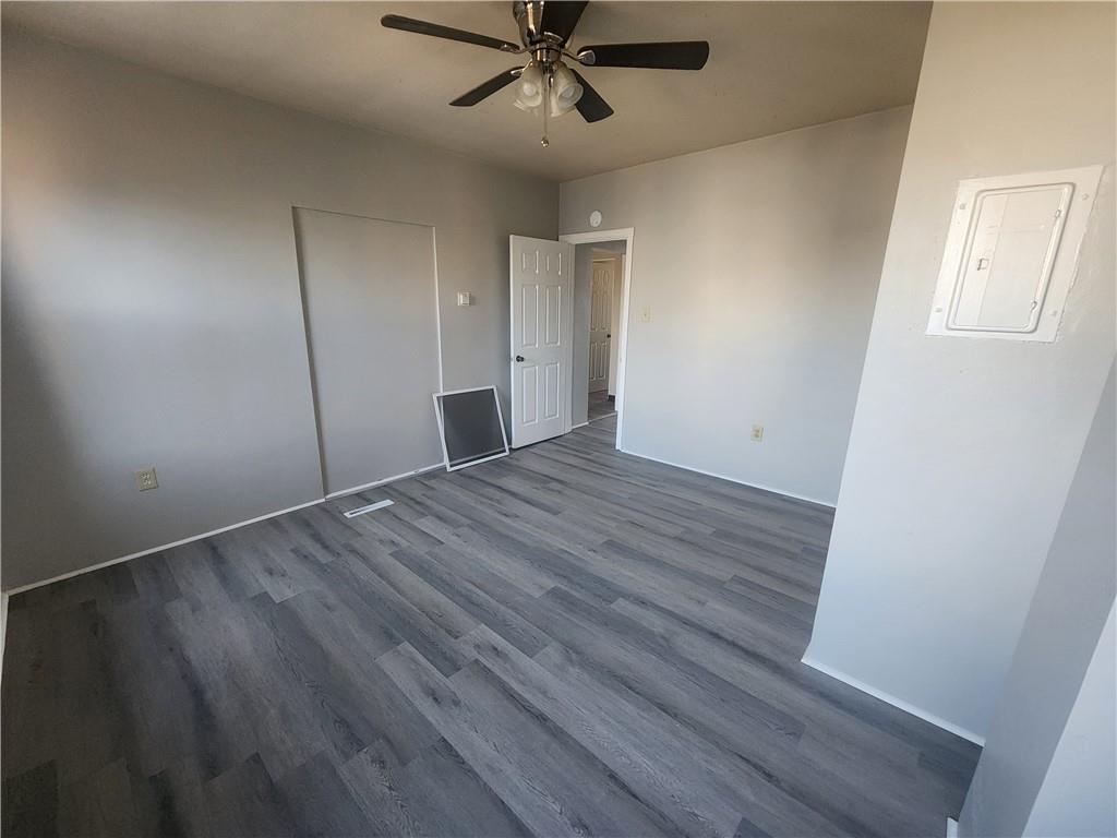 306 Campbell Street McKees Rocks, PA 15136 - Photo 14 of 28 an empty room with wooden floor fan and windows