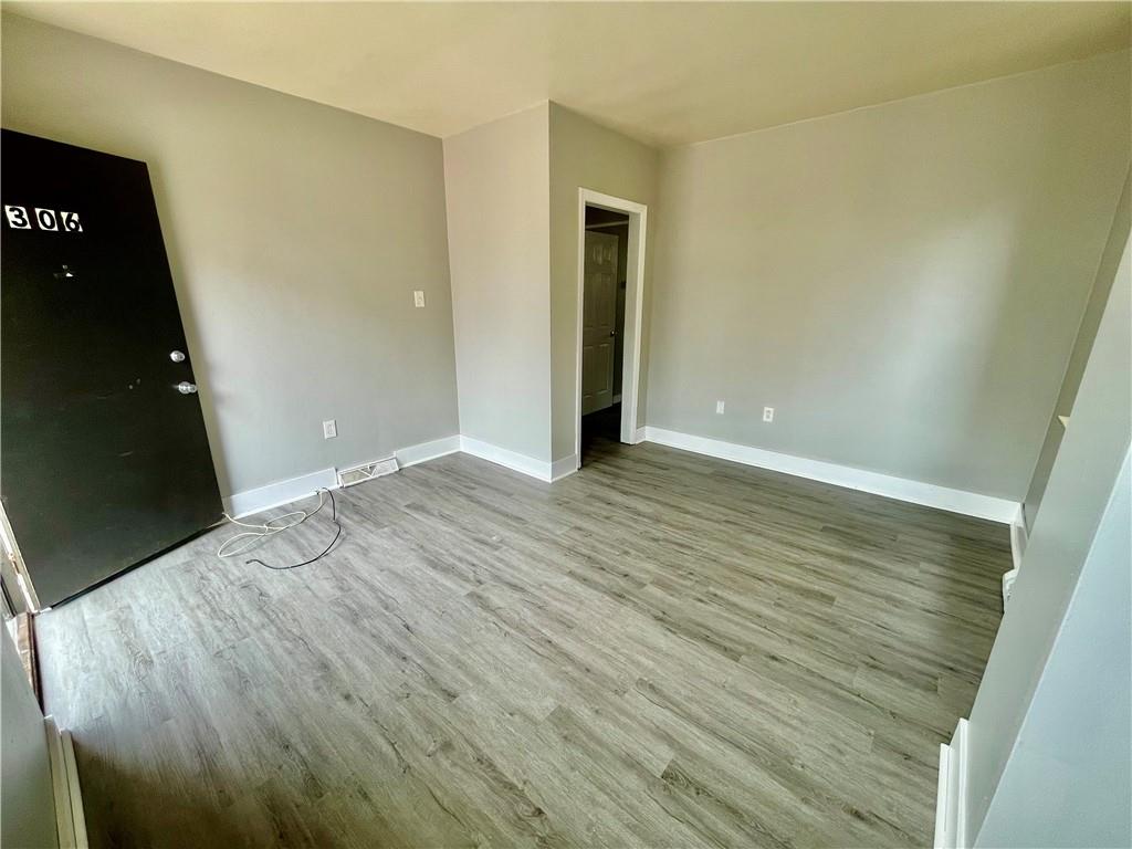 306 Campbell Street McKees Rocks, PA 15136 - Photo 17 of 28 wooden floor in an empty room