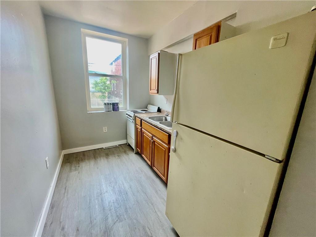 306 Campbell Street McKees Rocks, PA 15136 - Photo 20 of 28 a kitchen with sink a refrigerator and a stove