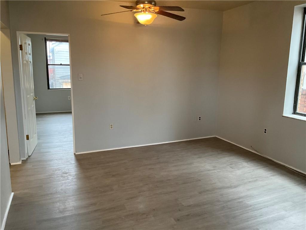 306 Campbell Street McKees Rocks, PA 15136 - Photo 25 of 28 an empty room with wooden floor and windows
