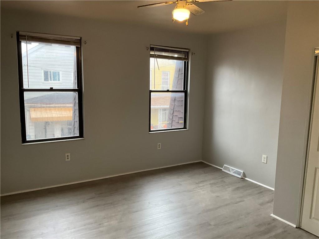 306 Campbell Street McKees Rocks, PA 15136 - Photo 28 of 28 an empty room with windows and closet