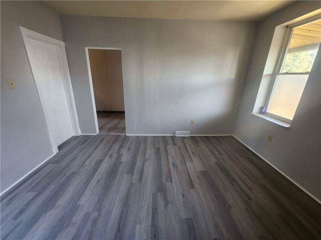 306 Campbell Street McKees Rocks, PA 15136 - Photo 5 of 28 an empty room with wooden floor and windows