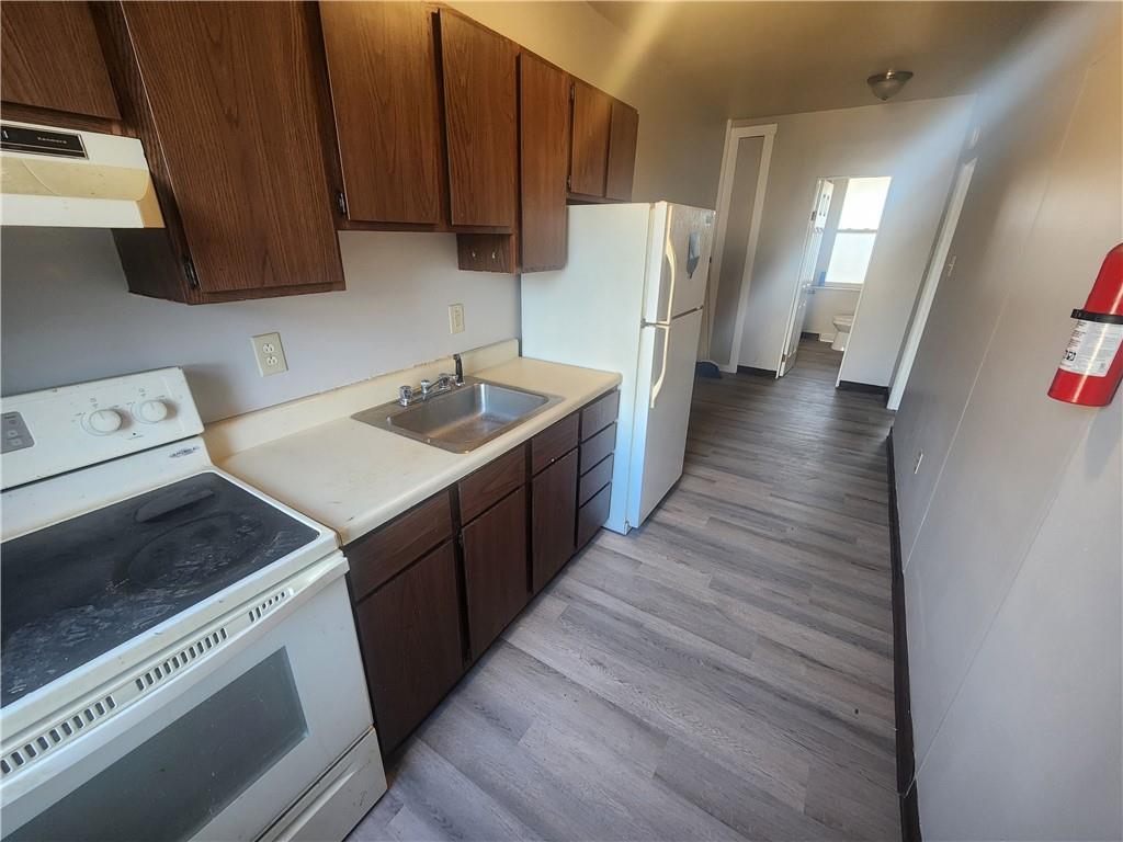 306 Campbell Street McKees Rocks, PA 15136 - Photo 6 of 28 a kitchen with a sink and a refrigerator