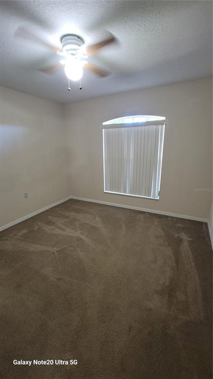 11028 Versailles Boulevard Clermont, FL 34711 - Photo 14 of 21 a view of an empty room with a window
