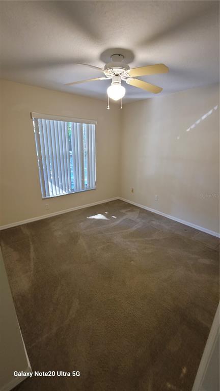 11028 Versailles Boulevard Clermont, FL 34711 - Photo 15 of 21 a view of an empty room with window and wooden floor