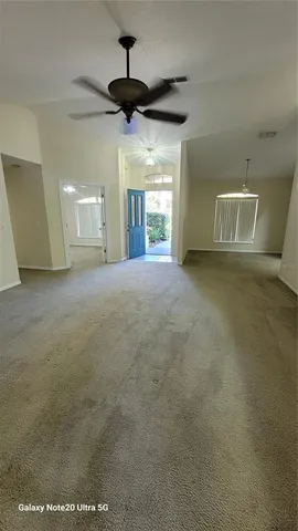 a view of a livingroom with a ceiling fan and window