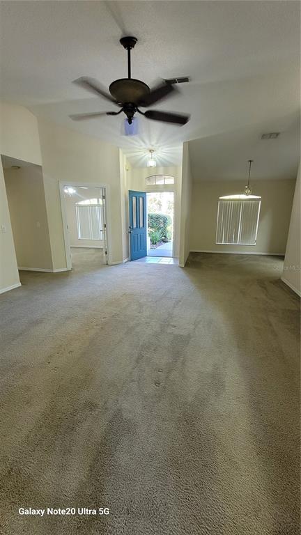 11028 Versailles Boulevard Clermont, FL 34711 - Photo 4 of 21 a view of a livingroom with a ceiling fan and window