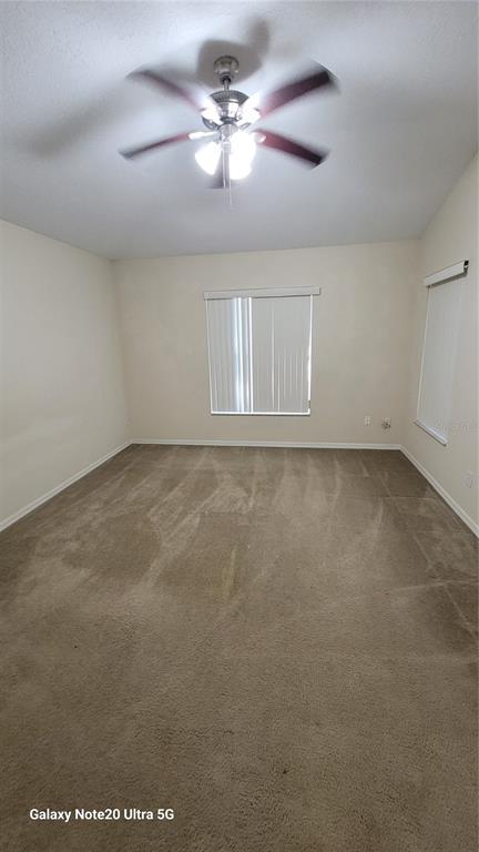 11028 Versailles Boulevard Clermont, FL 34711 - Photo 9 of 21 a view of an empty room with a window