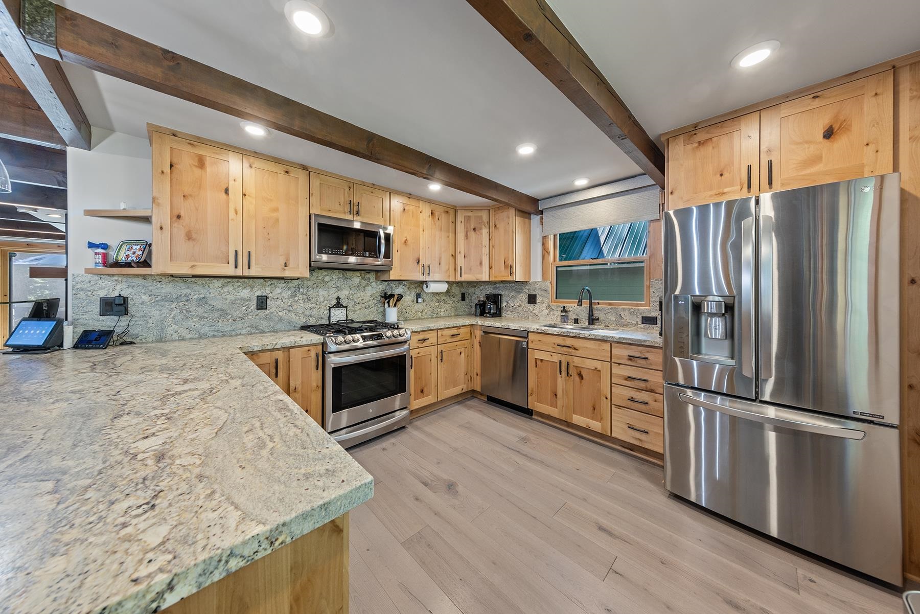 4530 Muletail Drive Carnelian Bay, CA 96140 - Photo 6 of 24 a kitchen with stainless steel appliances granite countertop a stove top oven a sink and a refrigerator
