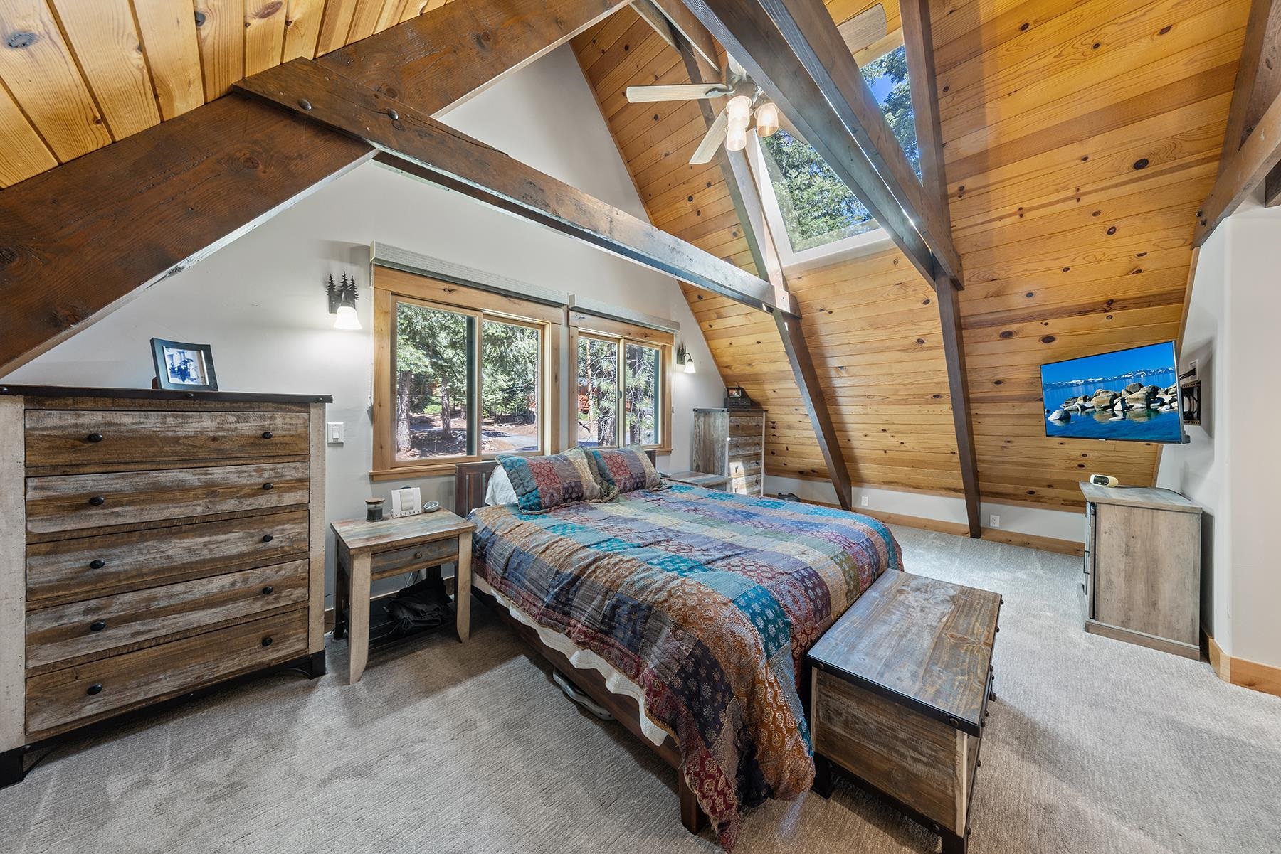 4530 Muletail Drive Carnelian Bay, CA 96140 - Photo 8 of 24 a bedroom with a bed and a dresser next to a window