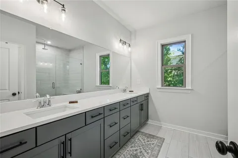a kitchen with counter top a sink appliances and cabinets