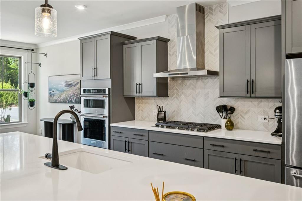1332 Stanley Park Drive Decatur, GA 30033 - Photo 5 of 75 a kitchen with stainless steel appliances kitchen island granite countertop a refrigerator and a stove top oven