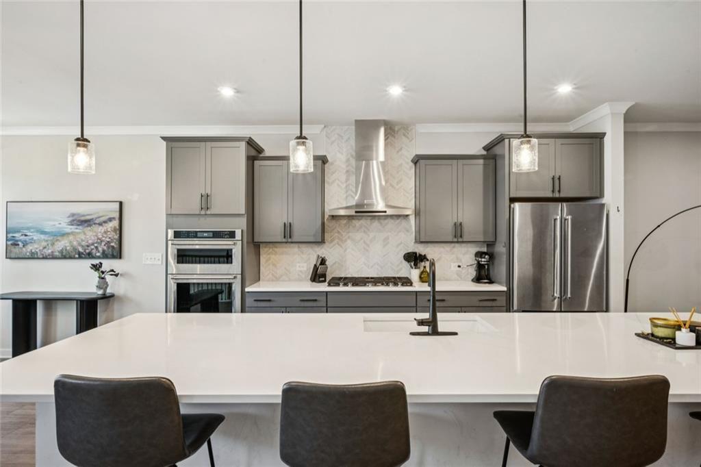 1332 Stanley Park Drive Decatur, GA 30033 - Photo 6 of 75 a kitchen with stainless steel appliances kitchen island granite countertop a sink a refrigerator and chairs