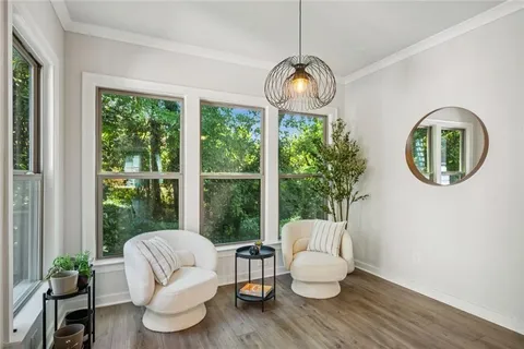 a very nice looking room with a large window and kitchen view