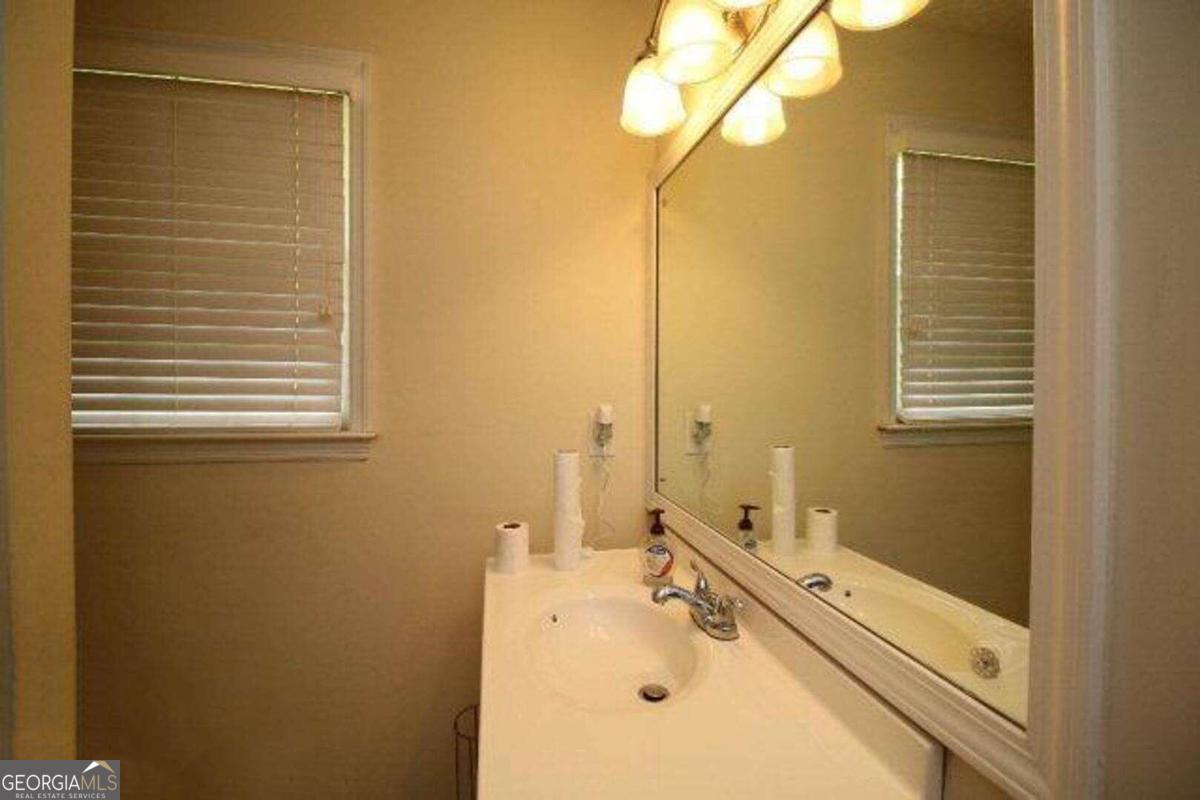 220 Providence Road Athens, GA 30606 - Photo 12 of 15 a bathroom with a tub sink and mirror
