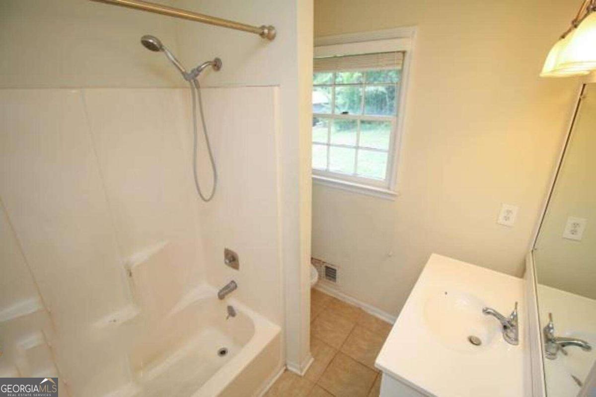 220 Providence Road Athens, GA 30606 - Photo 13 of 15 a bathroom with a bath tub with a shower