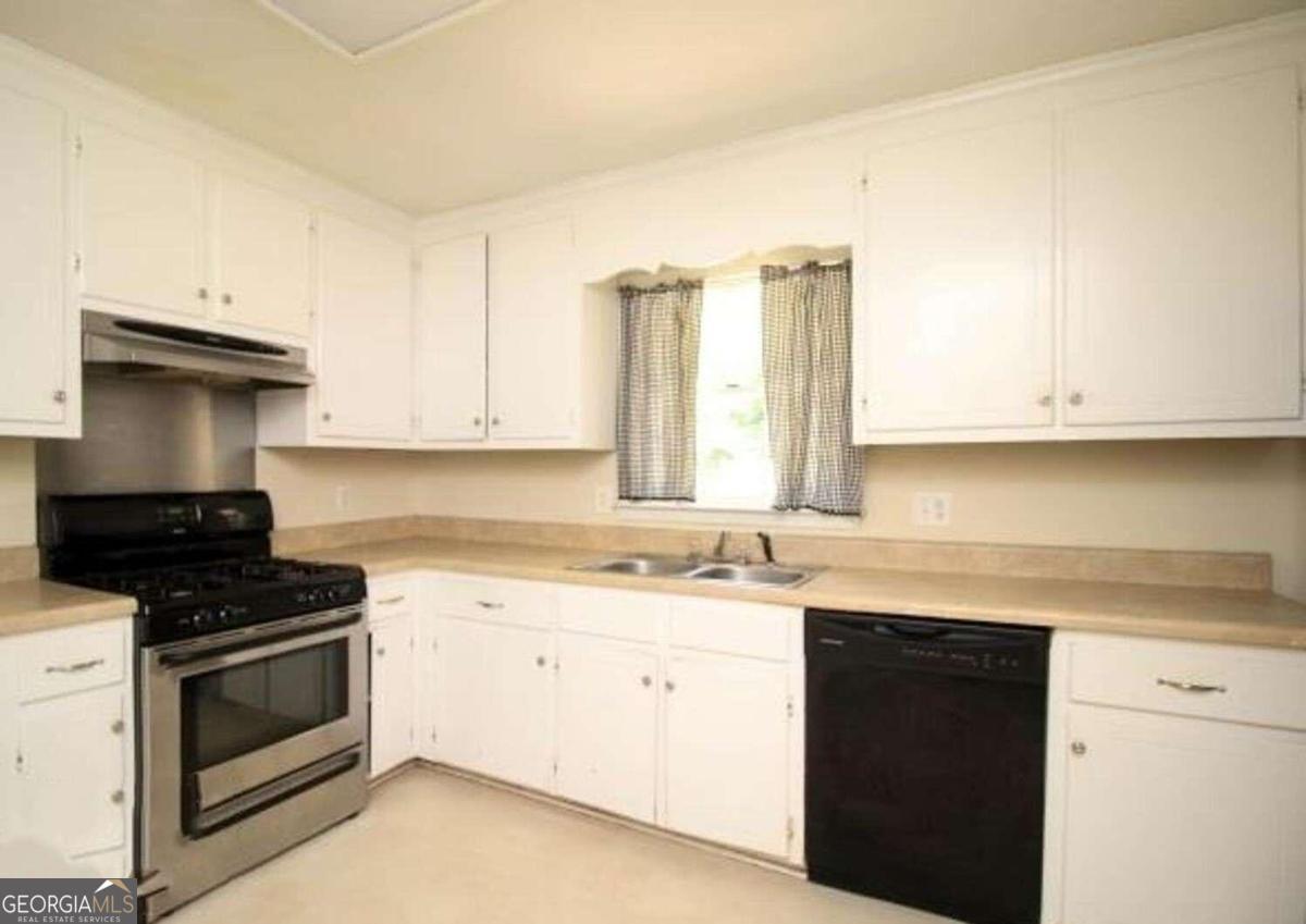 220 Providence Road Athens, GA 30606 - Photo 4 of 15 a kitchen with a sink stove and cabinets