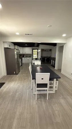 an empty room with wooden floor and furniture