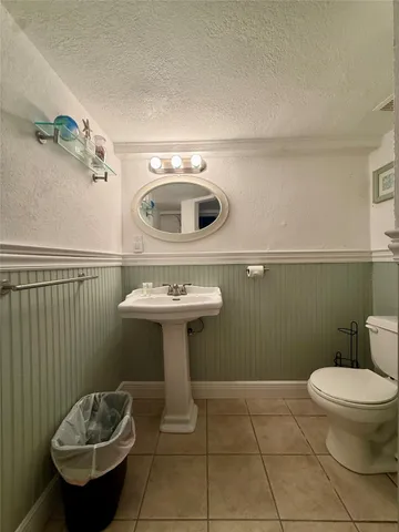 a bathroom with a sink toilet and a mirror
