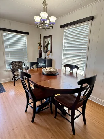 a view of a dining room with furniture wooden floor and chandelier