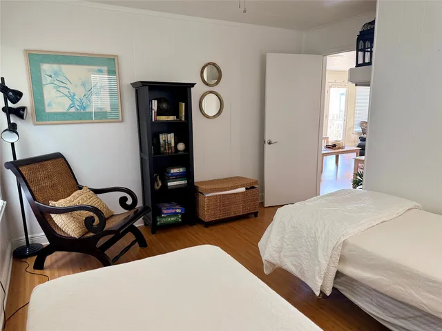 a bedroom with bed and a chair