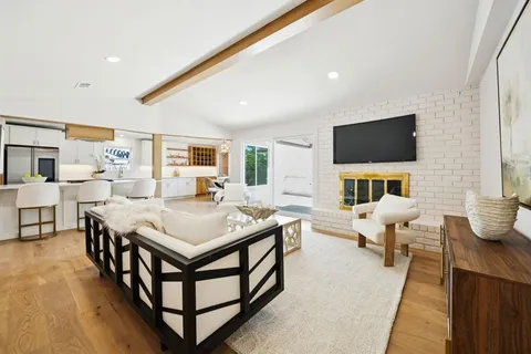 a spacious bedroom with a bed and a flat screen tv