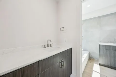 a bathroom with a sink a toilet and a mirror
