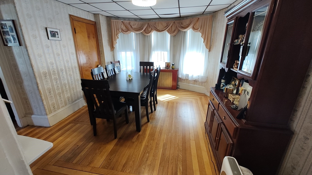 46 Irving Street Everett, MA 02149 - Photo 11 of 42 a view of a dining room with furniture and wooden floor