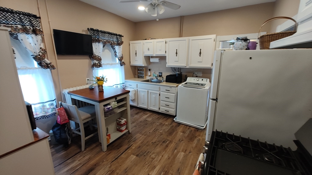 46 Irving Street Everett, MA 02149 - Photo 13 of 42 a utility room with cabinets washer and dryer