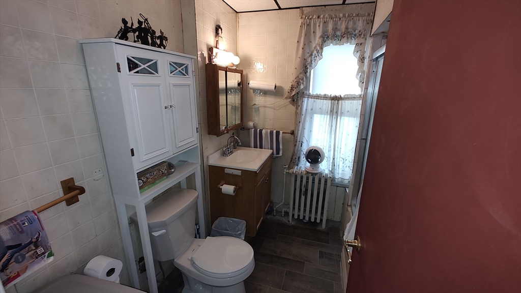 46 Irving Street Everett, MA 02149 - Photo 16 of 42 a bathroom with a toilet a sink and shower