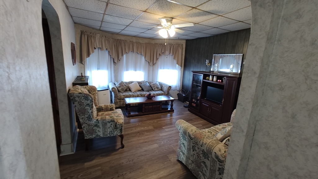 46 Irving Street Everett, MA 02149 - Photo 17 of 42 a living room with furniture a lamp and a fireplace