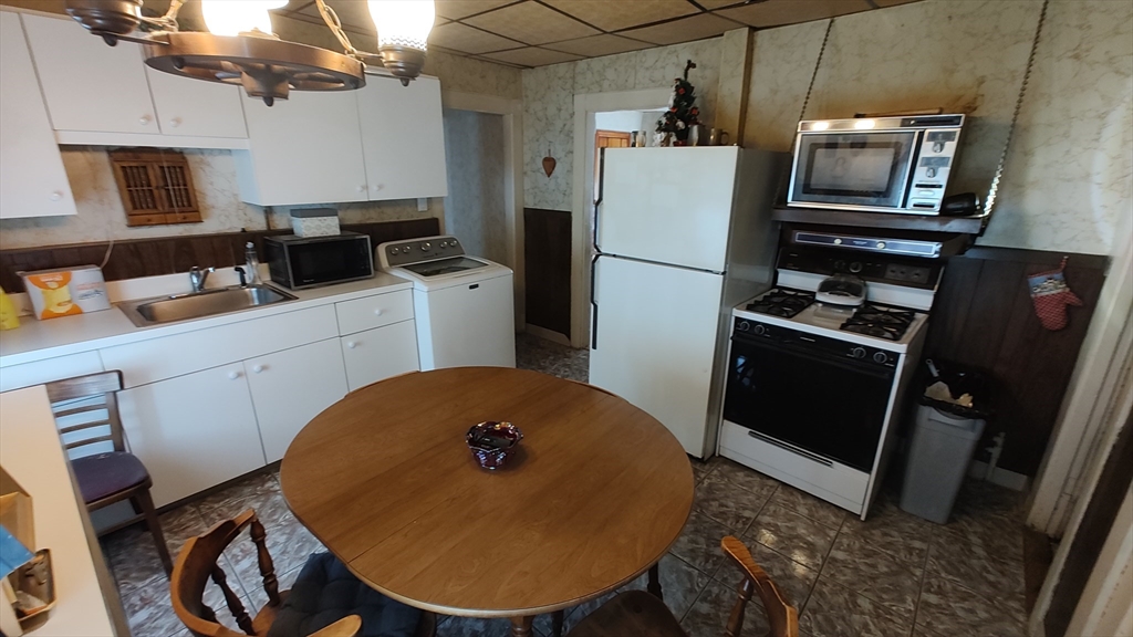 46 Irving Street Everett, MA 02149 - Photo 22 of 42 a kitchen with a refrigerator and a stove top oven