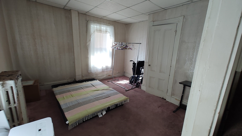 46 Irving Street Everett, MA 02149 - Photo 24 of 42 a bedroom with a bed and a window