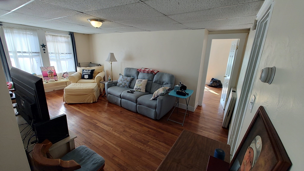 46 Irving Street Everett, MA 02149 - Photo 26 of 42 a living room with furniture and a flat screen tv