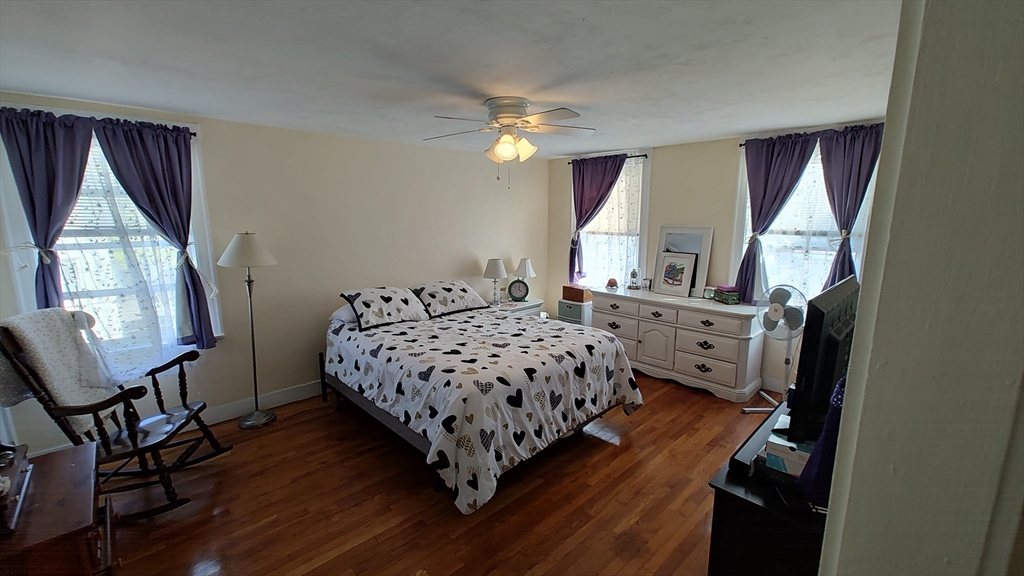 46 Irving Street Everett, MA 02149 - Photo 30 of 42 a bedroom with a bed window and a chandelier