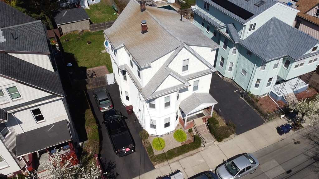 46 Irving Street Everett, MA 02149 - Photo 3 of 42 an aerial view of residential houses with outdoor space