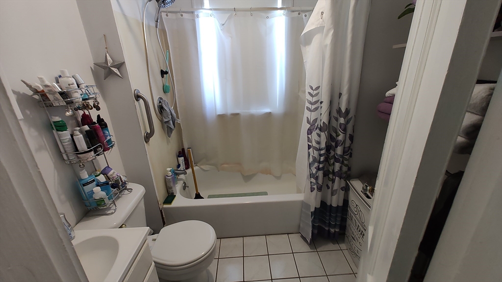 46 Irving Street Everett, MA 02149 - Photo 36 of 42 a bathroom with a toilet and a shower