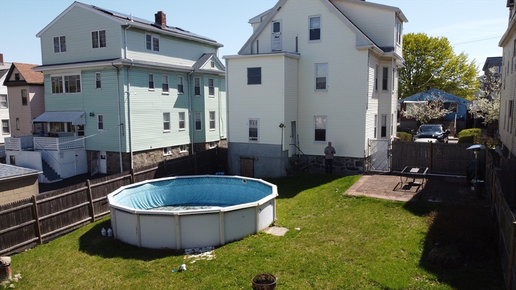 46 Irving Street Everett, MA 02149 - Photo 5 of 42 a view of a backyard with table and chairs potted plants