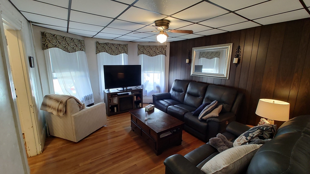 46 Irving Street Everett, MA 02149 - Photo 8 of 42 a living room with furniture and a flat screen tv
