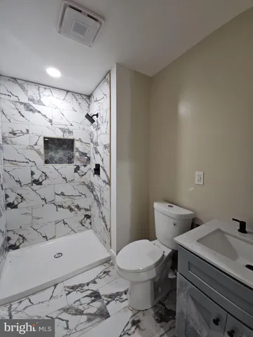 a bathroom with a toilet and shower