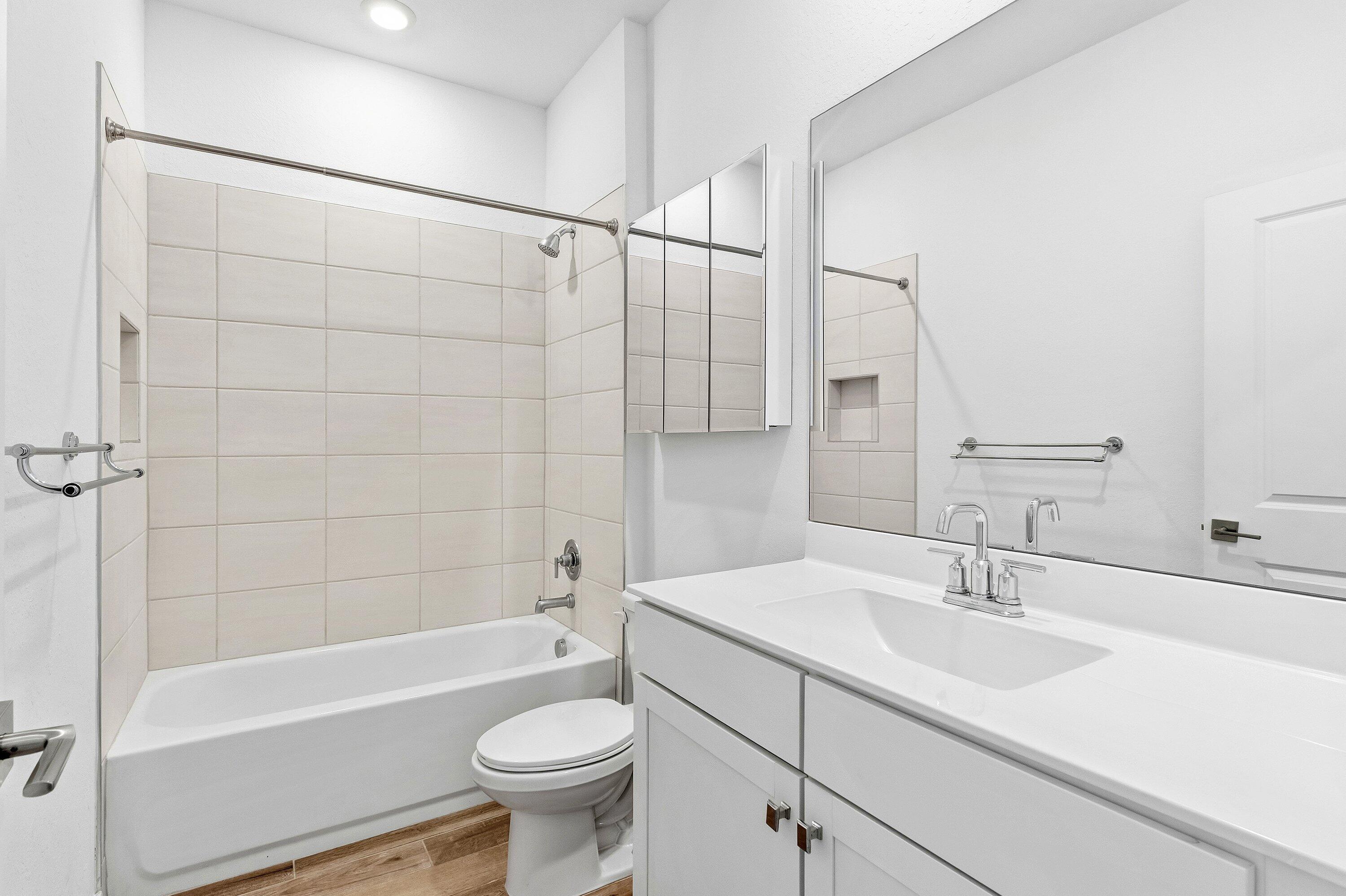 18446 Claybrook Street Jupiter, FL 33458 - Photo 16 of 25 a bathroom with a sink a toilet and a bathtub